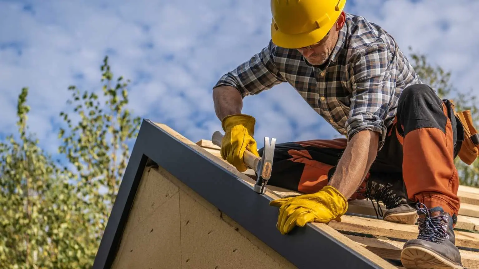 Roofer installing new roof of a residential house