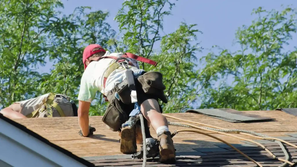 Professional roofing contractor inspecting a residential roof in Rochester MN