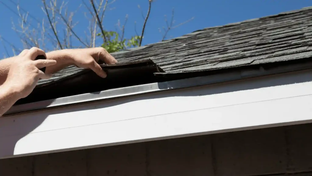 Professional inspecting asphalt shingles and roof edge on a residential home in Rochester MN