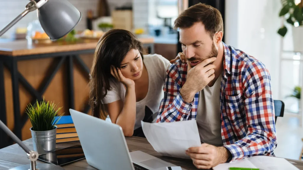 Homeowners reviewing roof insurance claim documents