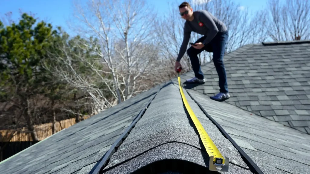 Roofing contractor measuring a home for roof replacement in Rochester MN